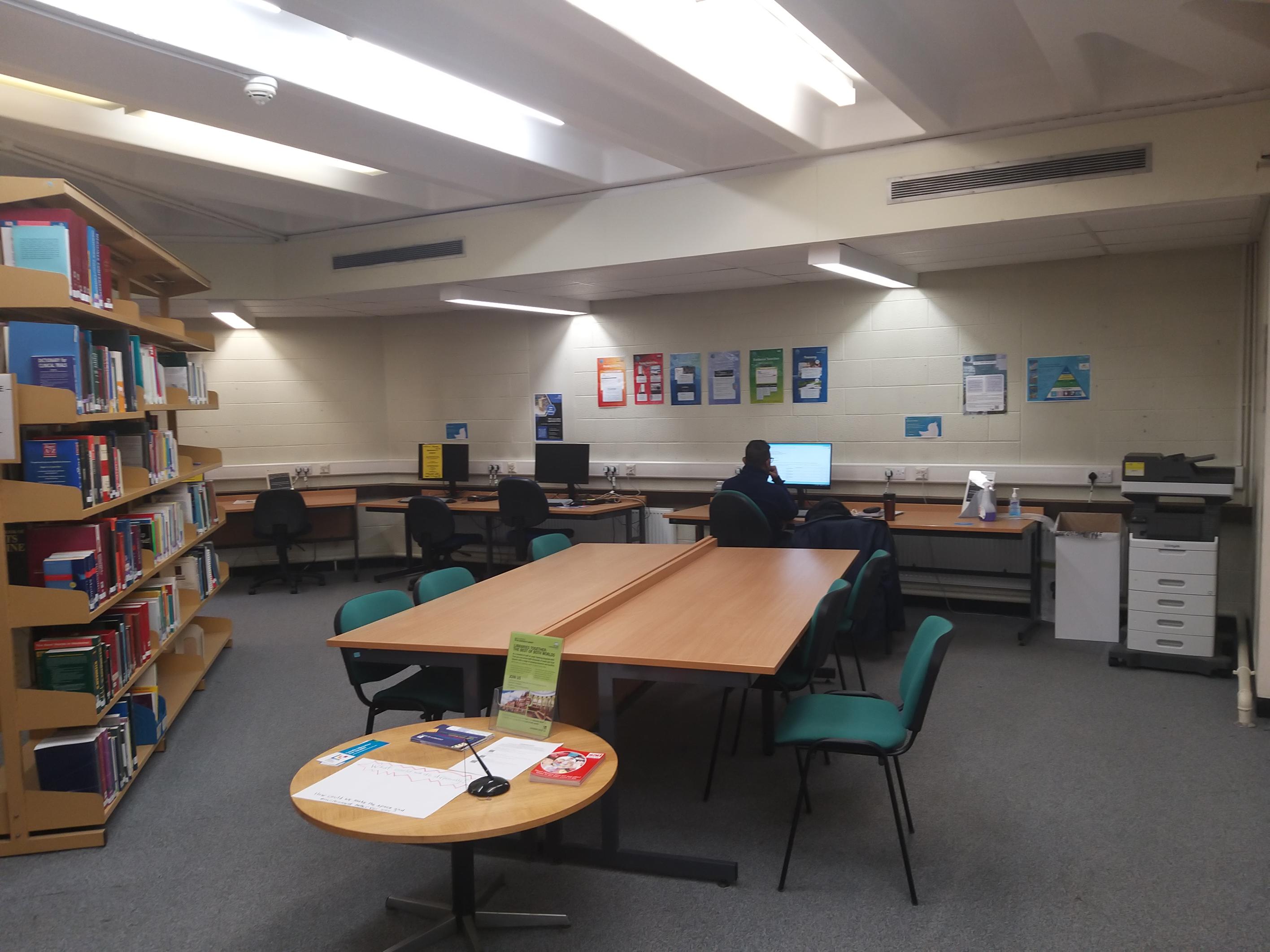 Photo of the NHS Pcs and a overlooking study space in the library in the Clinical Sciences Building