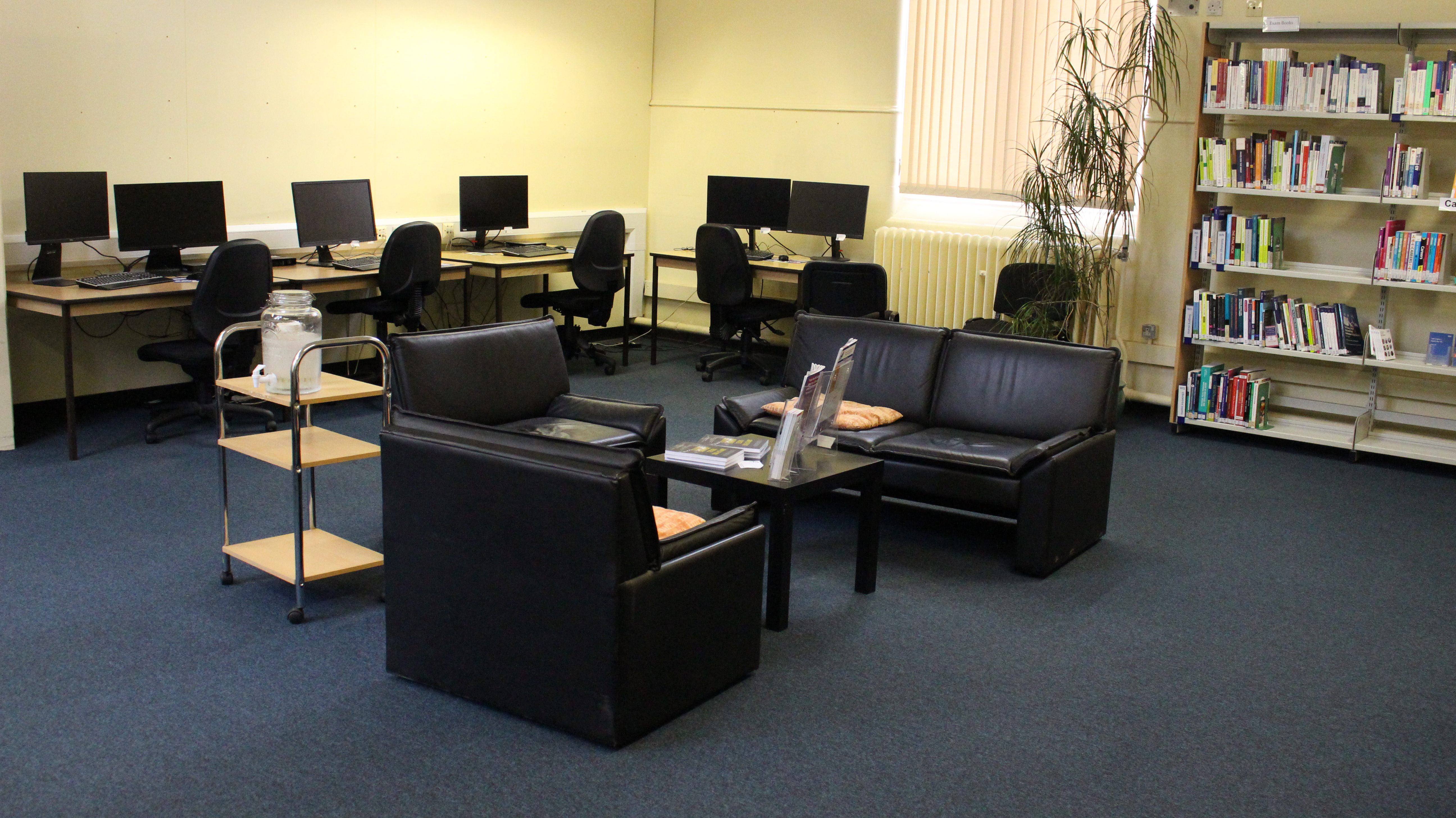 computers, sofa seating and careers/exams books on freestanding shelving unit